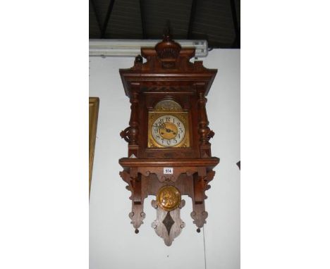 An old oak wall clock, in working orderClock works1 spring wound to limit