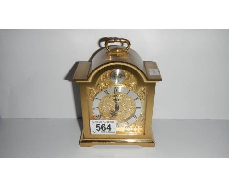 A brass carriage style clock