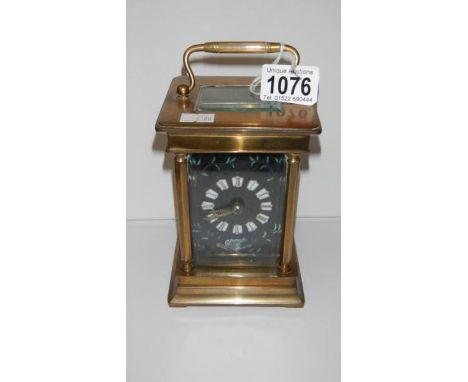 A large brass carriage clock with enamel faceGlass panel on roof is chipped on edgeClock workingComes with a key