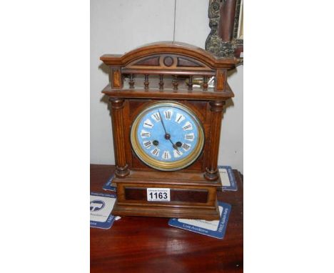 An oak bracket clock with enamel dial