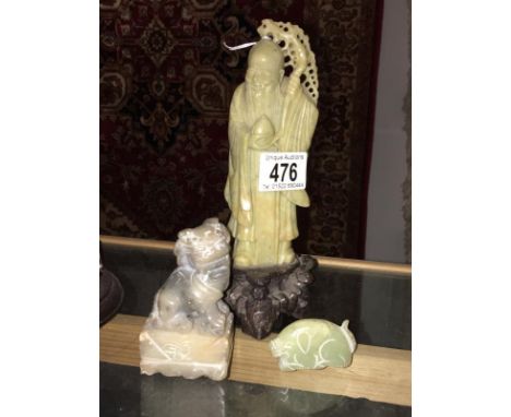 A Chinese soapstone? deity, a jade dog of foo and a jade pig