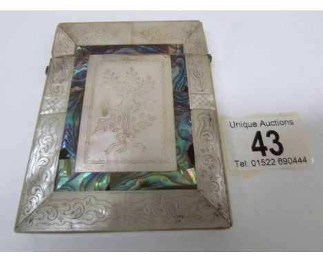 A mother of pearl card case banded with abalone and engraved