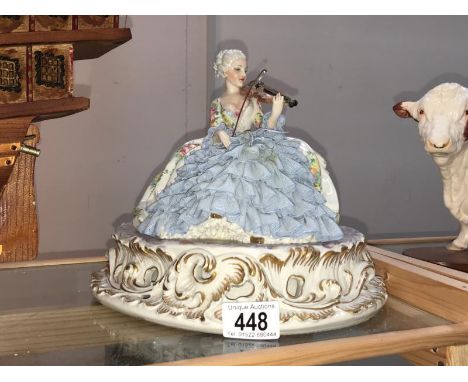 A fine continental figure of a crinoline lady playing a violin