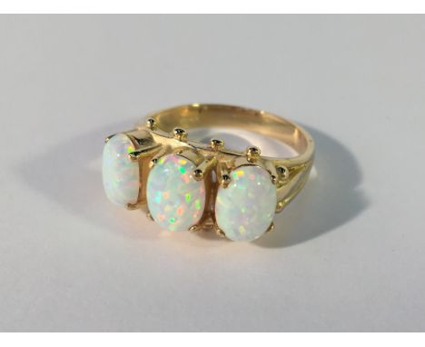 A large 3 stone 9ct yellow gold opal ring size O