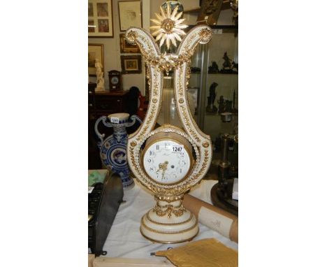 A beautiful French ormolu mounted white marble lyre clock with swinging paste set bezel by Gille l'