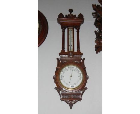 An oak cased aneroid barometer