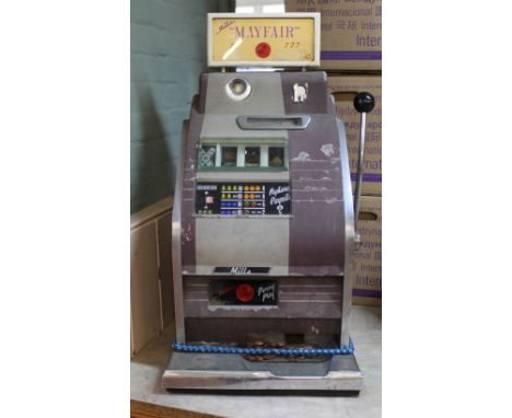 A Mills Mayfair one armed bandit, this item is sold as a collectors item only and has not been subject to an electrical safet