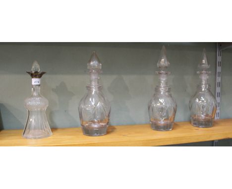 A set of three 19th Century cut glass decanters plus a silver rim thistle shaped decanter (as found)