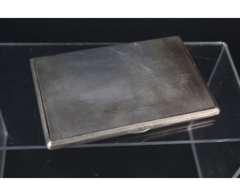 A large silver cigarette case with engine turned decoration