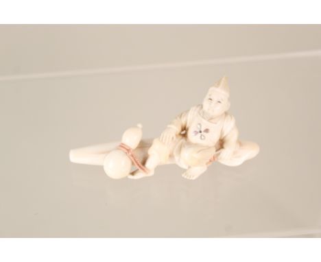 A Chinese ivory figure of a seated man, length 2 1/2" (red inset seal mark)
