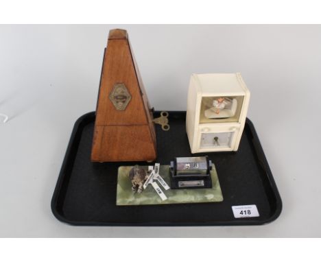 A metronome, novelty musical ballerina clock plus a desk calendar with cold painted dog on onyx base