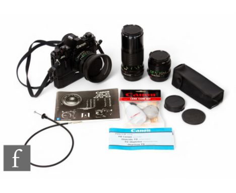 A Canon A-1 35mm film camera, with three Canon lenses, FS 50mm 1:18, FD 200mm 1:4 and FD 24mm 1:2.8, together with motor driv