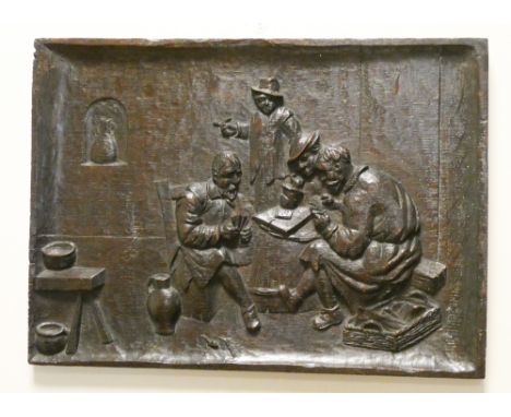 A medieval style carved wood wall panel with figures playing cards 131/2" x 19"
