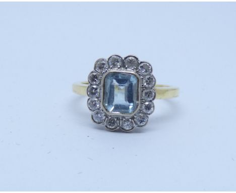 An 18 carat gold aquamarine and diamond cluster ring, ring size K