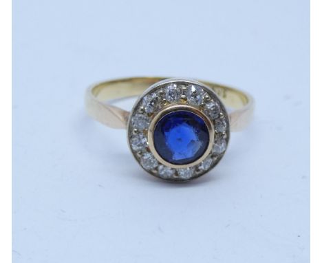 Sapphire and diamond circular cluster ring, yellow 14k shank stamped 585. Ring size R