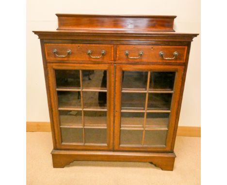 An Edwardian inlaid mahogany glazed two door bookcase fitted two drawers standing on bracket style feet 41" wide 