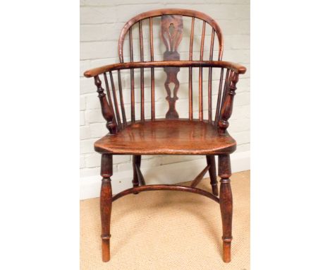 A yew wood stick back elbow chair standing on hooped base