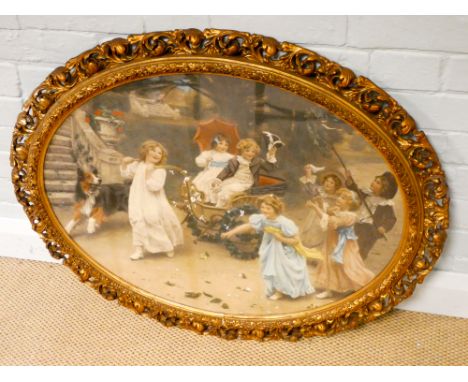 An oval Victorian coloured print of children playing in a good quality acanthus decorated gilt frame, the frame is approx 27"