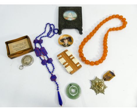 Miniature Indian watercolour of the Taj Mahal in a carved hardwood frame, jade disc, a Watkins bee meter, row of amber style 