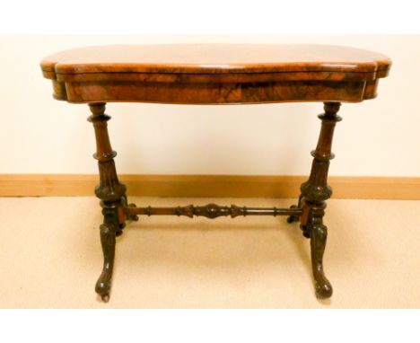 A Victorian figured burr walnut shaped top folding top card table on a cross stretcher pillar base 