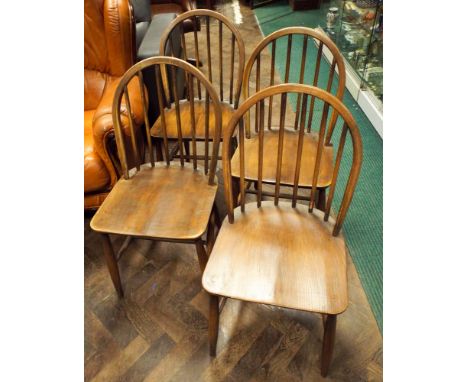 A set of four Ercol stick back dining chairs 