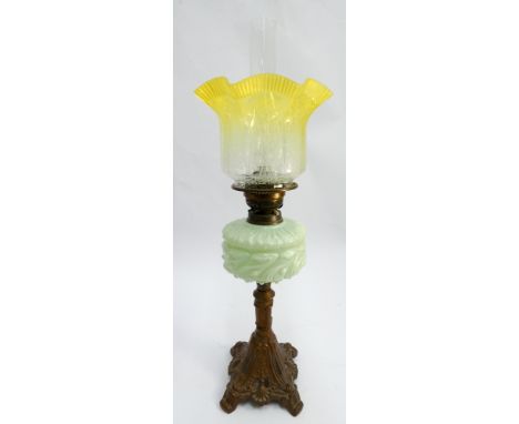Victorian oil lamp with vaseline glass reservoir and lemon tinged flared shade, later converted to electricity. Height 56cm t