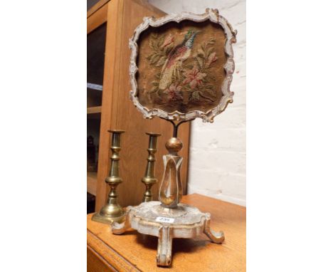 A small Victorian face table screen with needlework panel and a pair of brass candlesticks