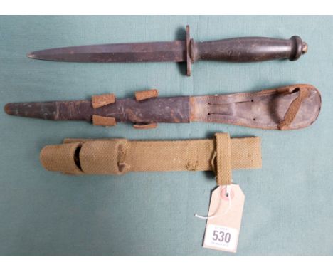 British army commando dagger complete with its leather scabbard and canvas frog   A small part of the point of the dagger is 