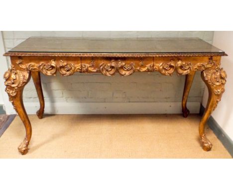 A decorative gilt console or centre table fitted one drawer standing on cabriole legs with lion mask feet 54"x22"