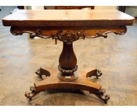 Victorian rosewood fold over top card table on pillar and quatreform base.