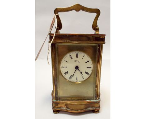 A gilt brass carriage clock cream enamel dial signed Henley, 17cm tall include. handle 