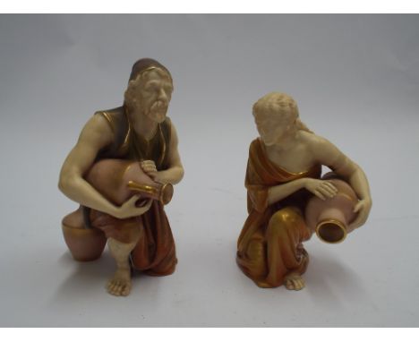 Pair of Royal Worcester blush ivory and gilt decorated classical figures, kneeling water carriers. 17cm tall.   No obvious si