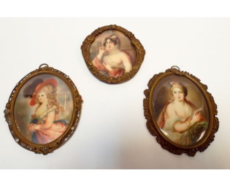 Set of three 19th Century portrait miniatures of ladies, after Heins, in gilt metal oval frames. Each approx 10cm long   Dark