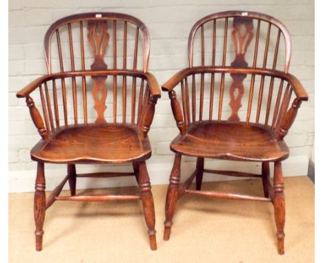 A pair of yew wood stick back Windsor elbow chairs 
