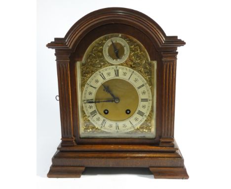 An Edwardian striking bracket clock with arched brass and silver dial and striking movement in oak case 
