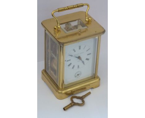 A fine 20th century repeater brass-cased Carriage Clock, the white enamel dial with Roman numerals and signed Matthew Norman 