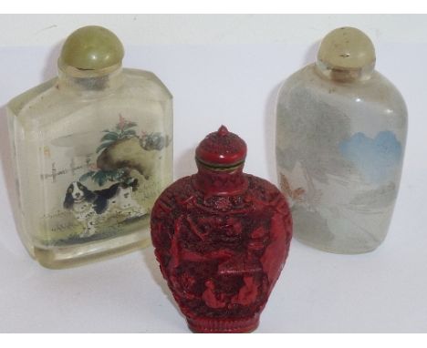 Three Chinese snuff bottles: an interior-painted glass bottle decorated with a dog and cat;  an interior-painted glass bottle