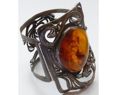 An Art Nouveau design silver Bangle (modern) central amber-coloured cabouchon and free-flowing form in high Art Nouveau style