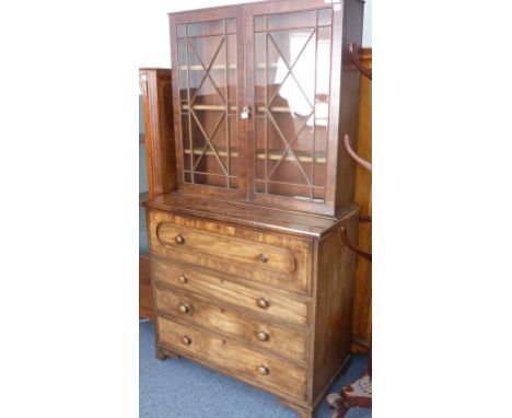 An early 19th Century mahogany Secretaire Bookcase, the single full width secretaire drawer opening to reveal pigeonholes and