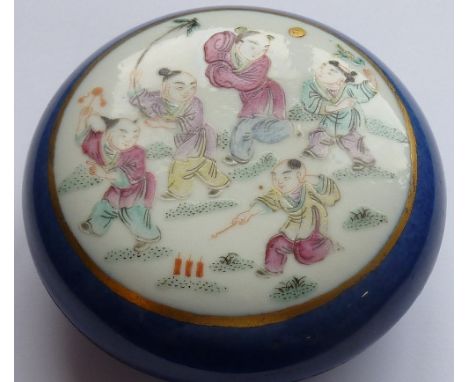 An early 20th century circular Chinese porcelain box, the cover decorated in famille rose enamels with a scene of children pl