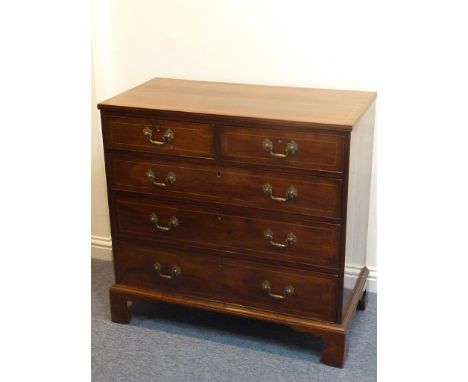 An early 19th century mahogany and boxwood-strung chest; reeded edge top above two half-width and three full-width graduated 