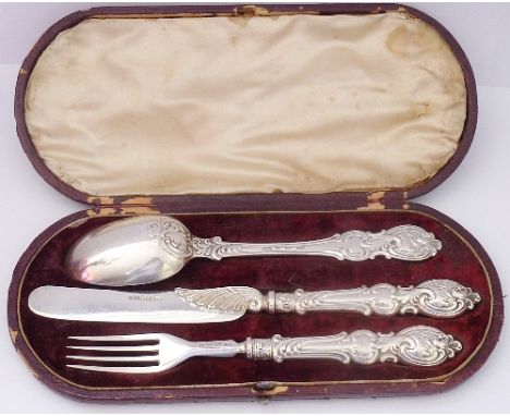 A cased three-piece hallmarked silver Knife, Fork and Spoon Set, each with elaborate double-struck handles, maker's mark A. H