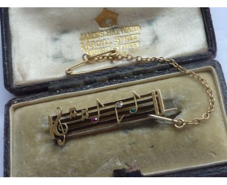 An unusual boxed yellow-metal Brooch modelled as a musical stave with notes etc.    CONDITION REPORT:  This appears to be in 