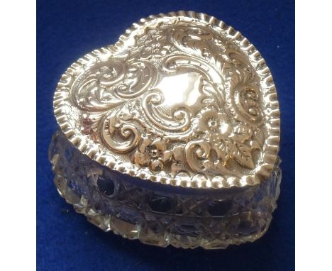 An Edwardian heart-shaped cut glass Trinket Box with hallmarked silver lid decorated repoussé style with 'C' scrolls, scrolli