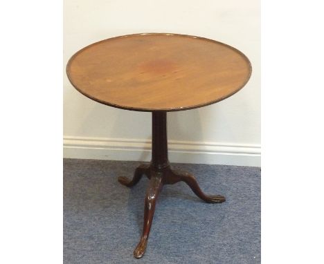A George III style circular mahogany tilt-top bird-cage Occasional Table; the swivelling circular gadrooned edge top above a 