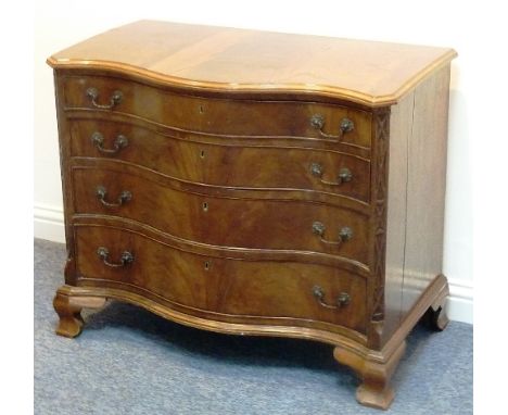 A George III serpentine-fronted mahogany Commode, four full-width graduated drawers with cast swan-neck handles and flanked b