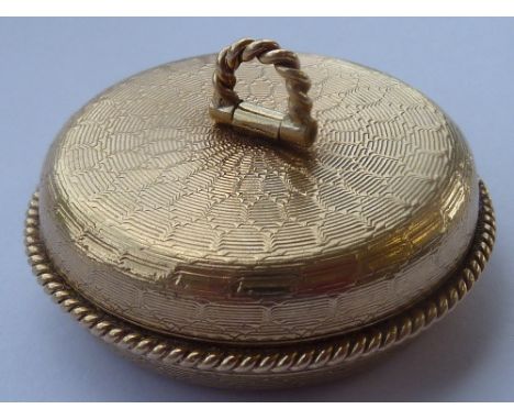 A circular 9-carat yellow gold Box and Cover, the cover with engine-turned decoration and hinged rope-style handle, the Cover