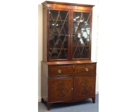 A large George III period mahogany secretaire bookcase; the outset cornice above a plain frieze and two glazed doors with loz