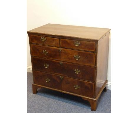 An early 18th century walnut Chest; the feather-banded top above two half-width and three full-width graduated drawers, each 