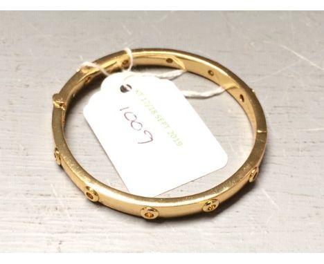 Modern hinged yellow metal bangle 